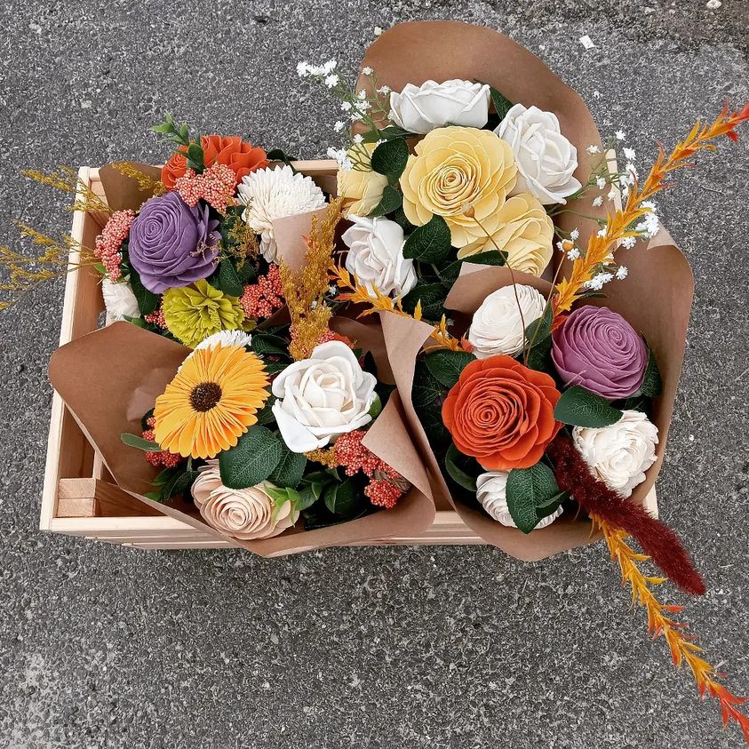 Two bouquets of sola flowers in a box.