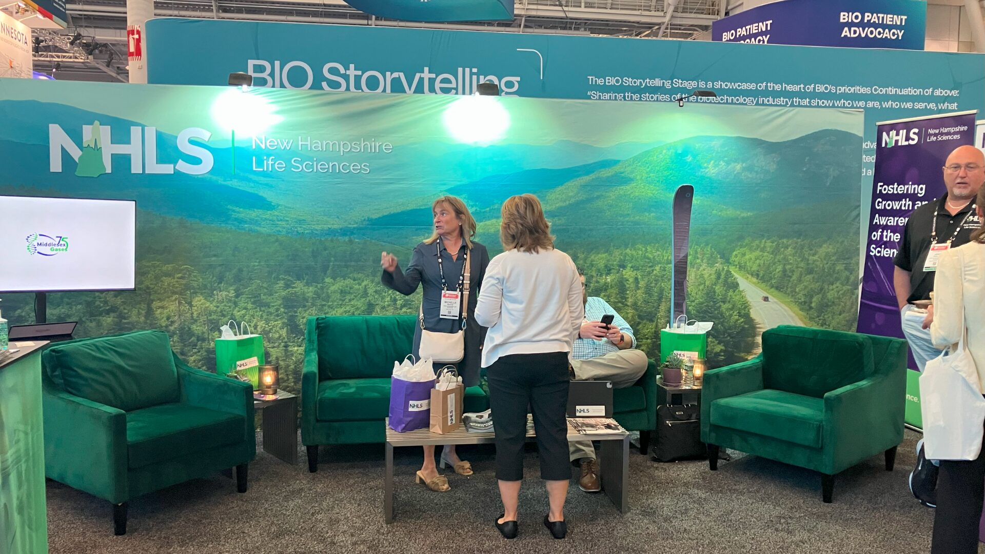 Conference booth with two women and the branding for New Hampshire Life Sciences.